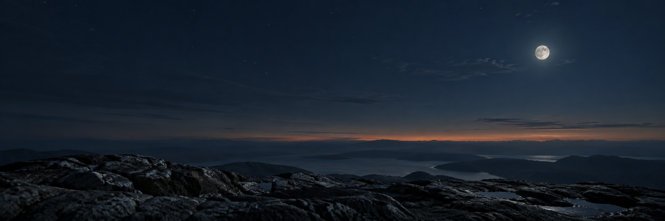 A quiet stone landscape beneath a moonlit sky.